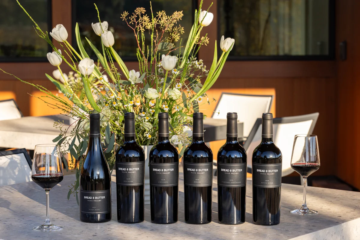 Bread & Butter Wines tasting room bottles on an outdoor table